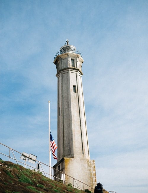 lighthouse with american flag, alcatraz island
