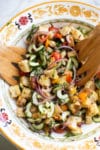 Panzanella or “Bread Salad” is a versatile recipe loaded with cucumbers, tomatoes, and olives and is great on its own, or alongside your favorite grilled meat. Since cucumbers and tomatoes are delicious year-round, this Panzanella recipe is great in the summer when you don’t want to heat up the kitchen, or in the cooler months when you’re craving a lighter, easy to prepare meal.