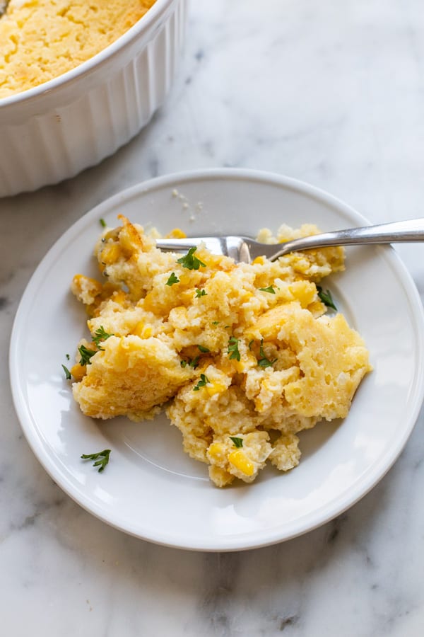 This creamy Corn Casserole is the perfect side dish to accompany your favorite holiday meals. Made with creamed corn, sour cream, and sweet cornbread mix, this recipe is sure to please and is a breeze to make! Only 7 ingredients!