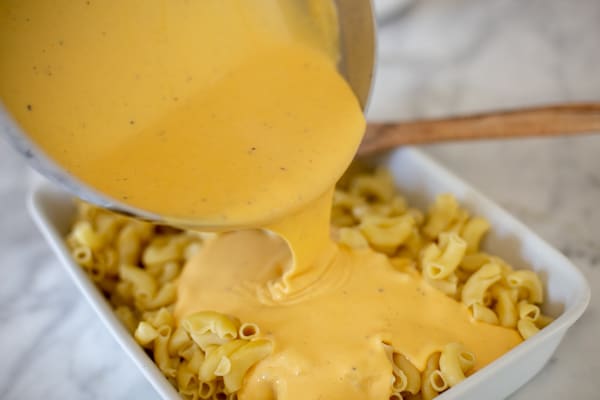 Cheese sauce poured over Homemade Baked Mac and Cheese