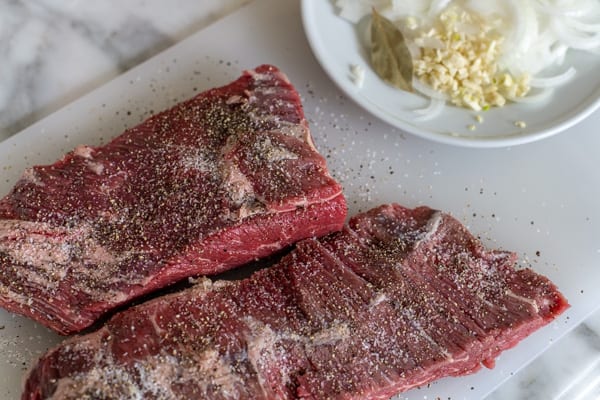 raw brisket on a cutting board