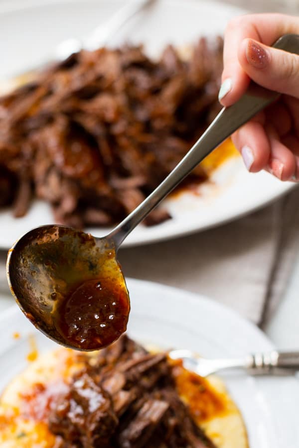 sauce being poured over brisket