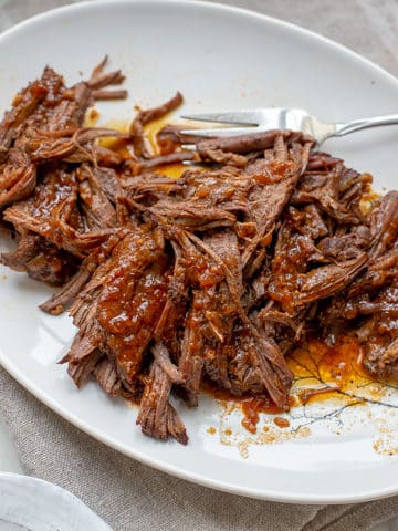 instant pot brisket shredded on a plate