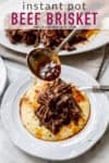 brisket and grits on white plate