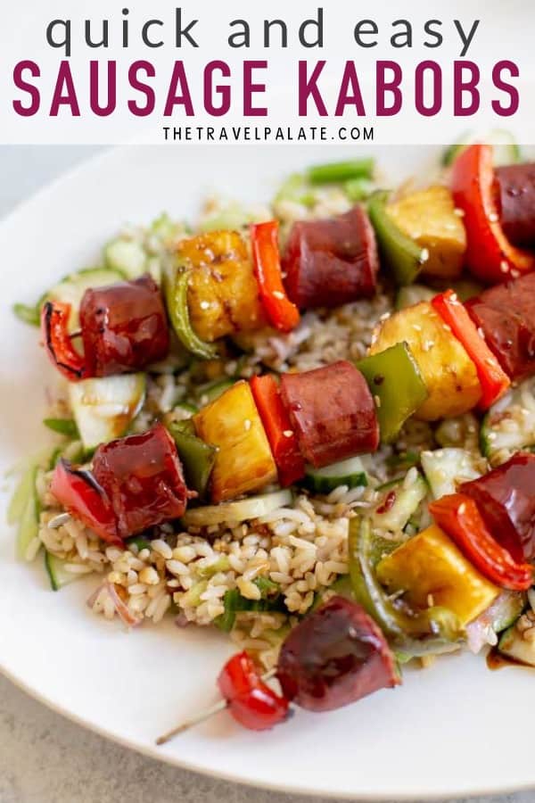 sausage skewers on a platter with rice