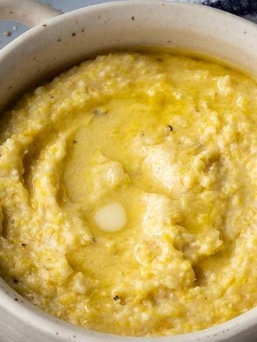 bowl of grits on a blue and white kitchen towel