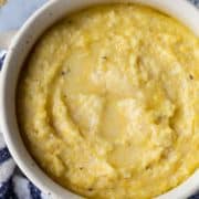 grits in a bowl with a blue and white kitchen towel underneath