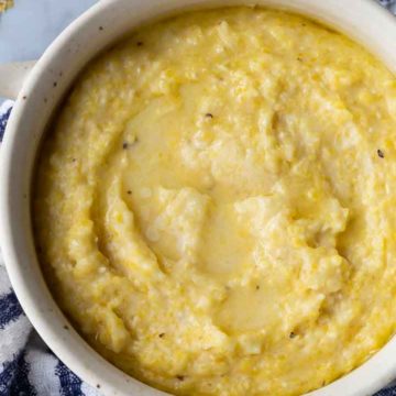 grits in a bowl with a blue and white kitchen towel underneath