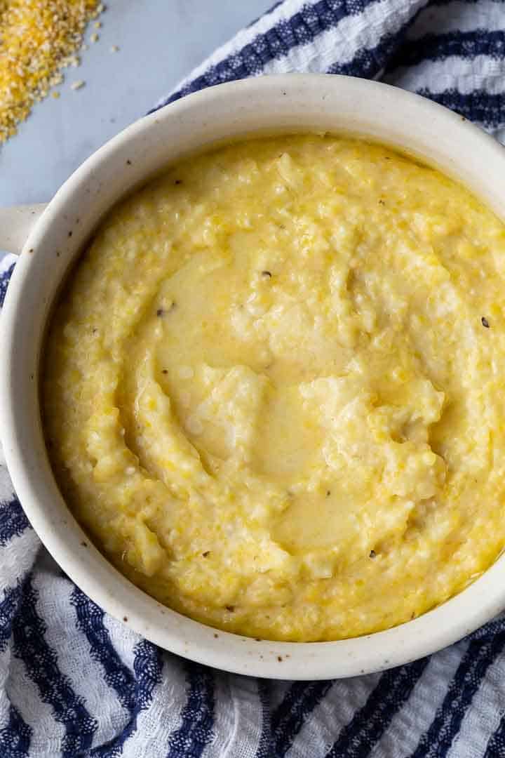 grits in a bowl with a blue and white kitchen towel underneath