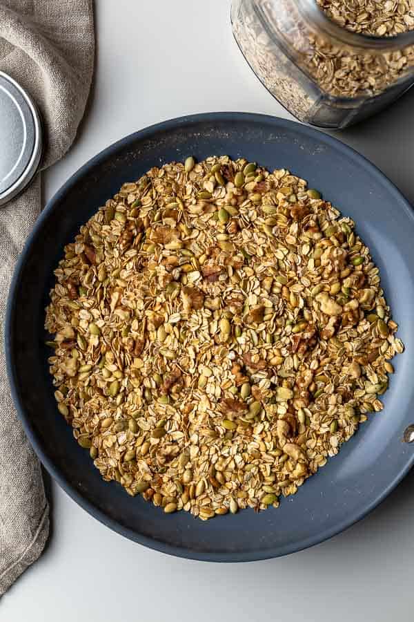 Toasting walnuts and pumpkin seeds in a non-stick skillet.