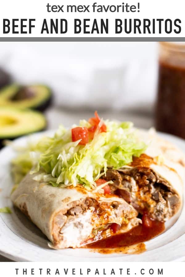 sliced burrito on plate with sauce and lettuce