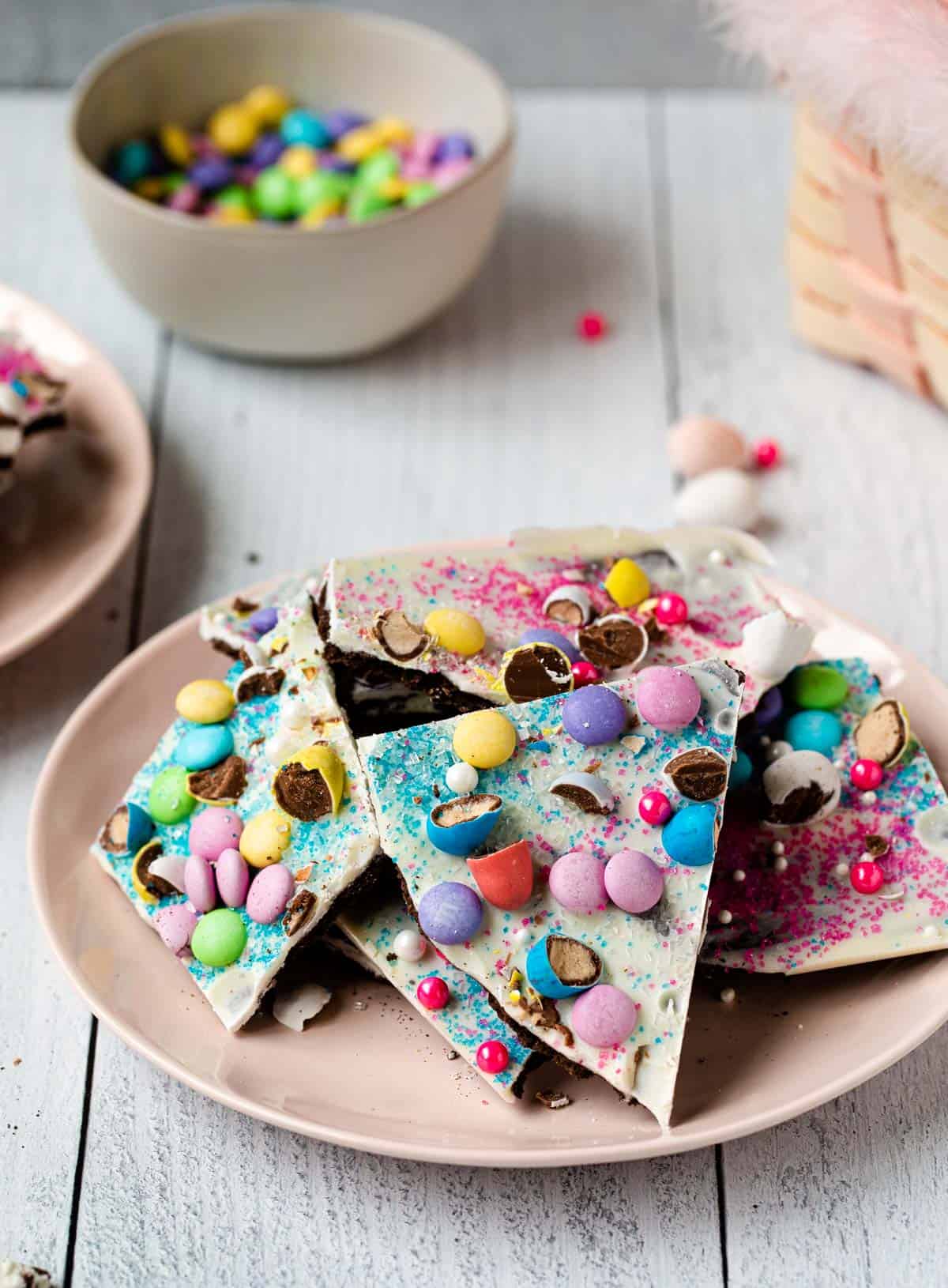 broken pieces of candy bark on a pink plate