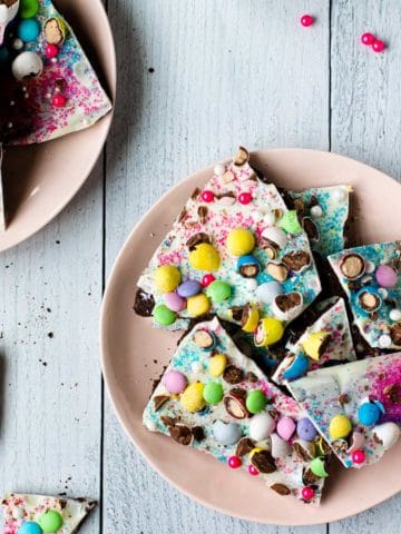 easter candy bark broken into pieced on a pink plate