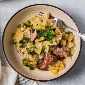 bowl with pasta and sausage with fork to side
