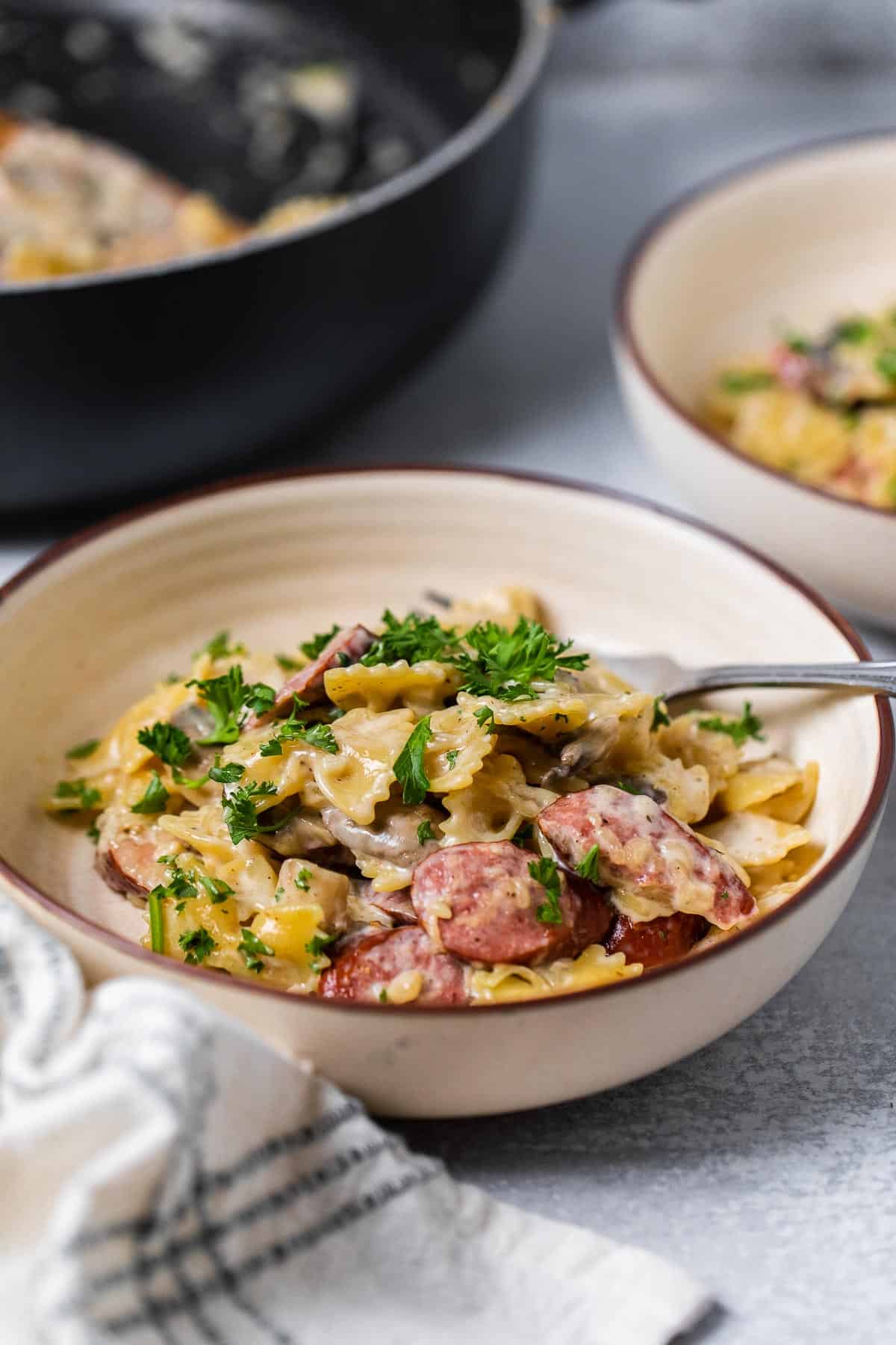 bowl of pasta with pan in background