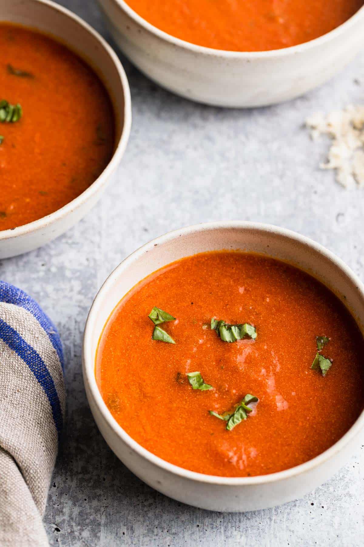 close up view of 3 bowls of tomato soup