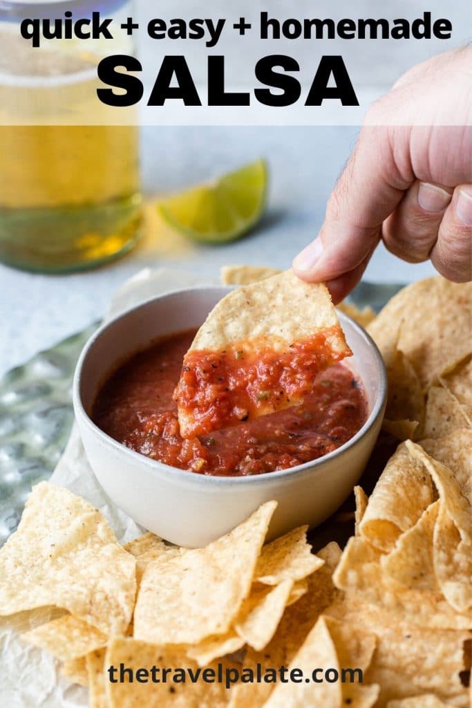 hand dipping a chip into a bowl of salsa with beer and lime in background and text overlay