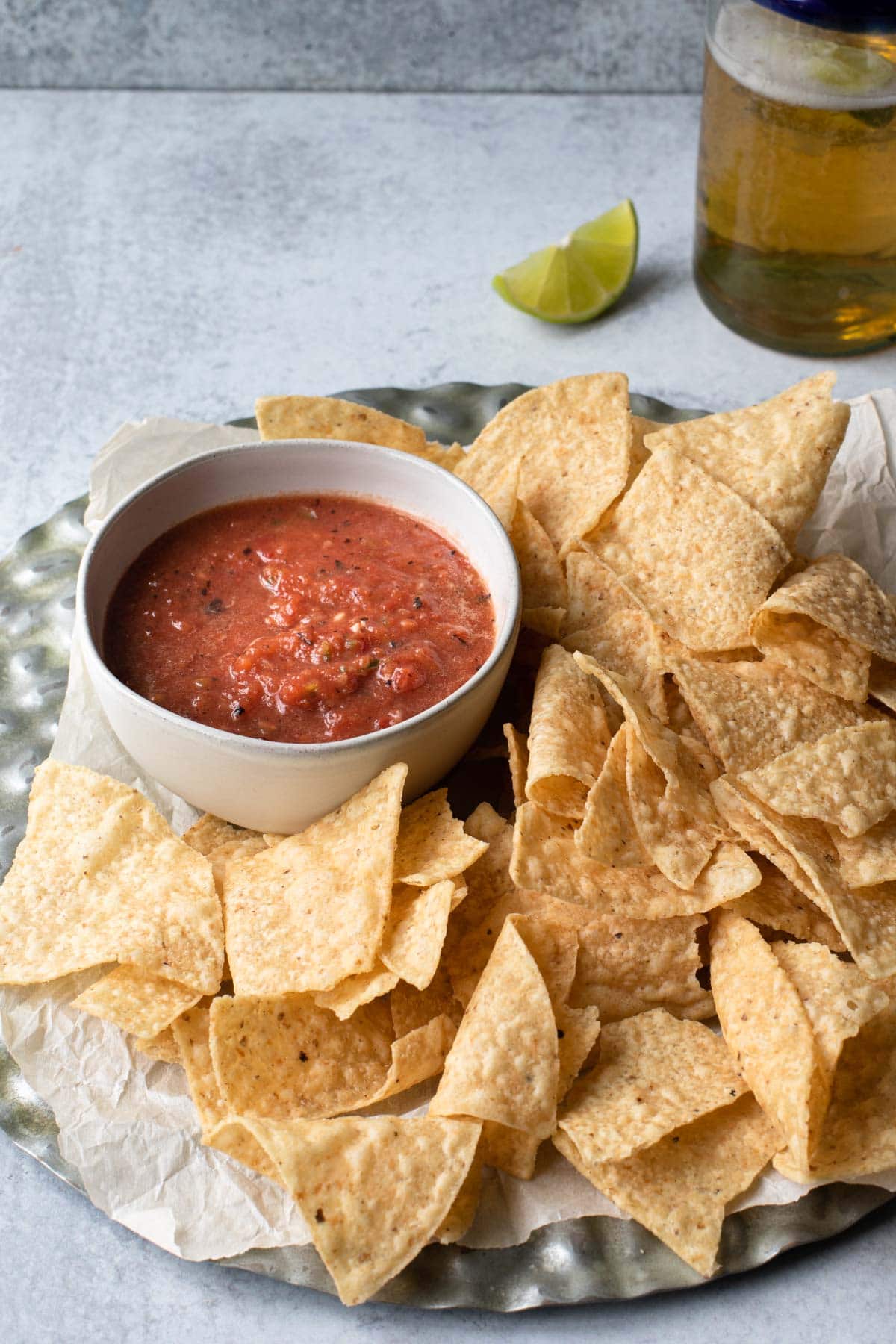 bowl of red salsa surrounded by tortilla chips