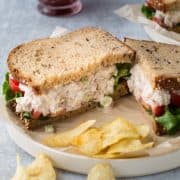 sandwich cut in half with a side of potato chips