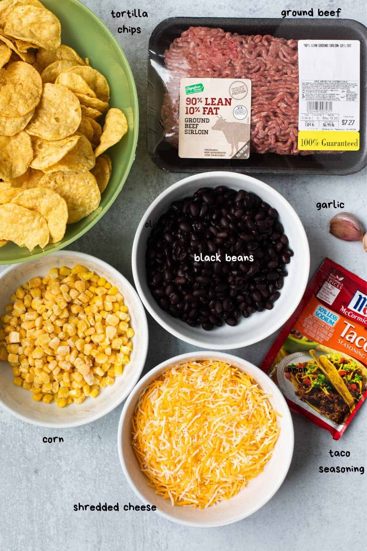 chips, corn, shredded cheese, black beans, taco seasoning, and uncooked ground beef