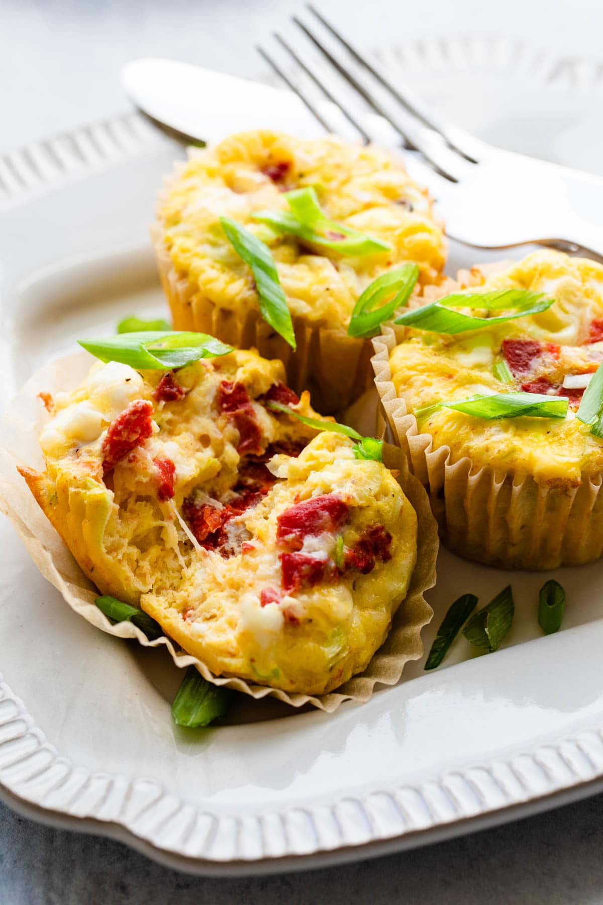 3 egg cups on a plate with one cut open