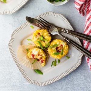 overhead shot of 3 breakfast egg cups on a plate with a fork and knife