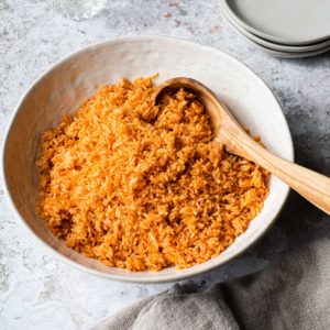 bowl of mexican rice with a wooden spoon