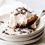 close up view of pie on a white plate with a fork