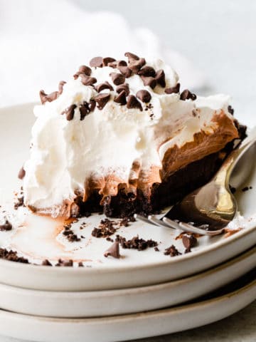 close up view of pie on a white plate with a fork