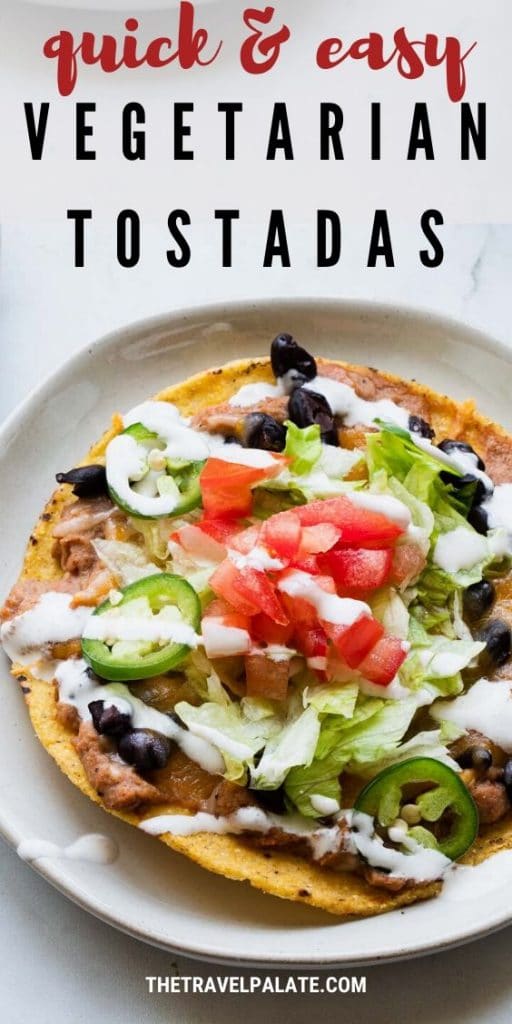 close up fo tostada with sour cream drizzled over top