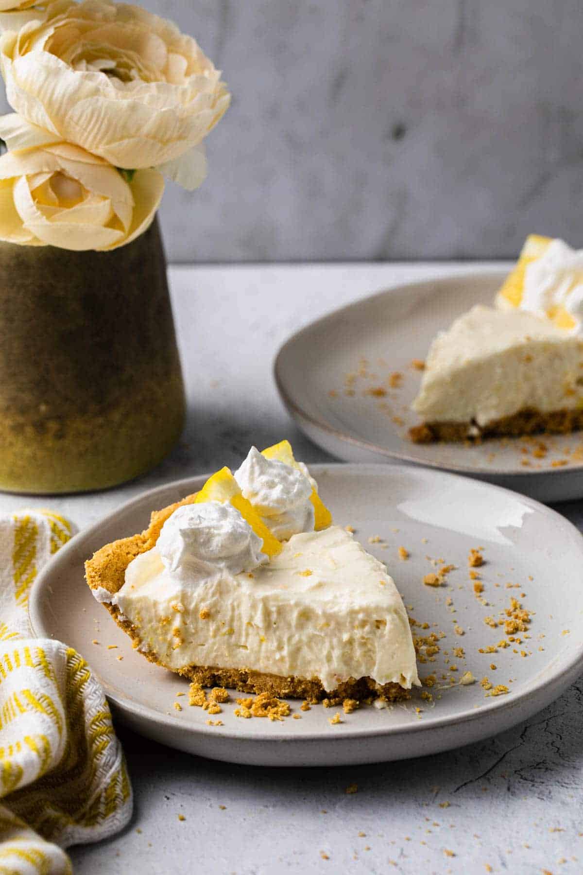 sliced lemon pie on plates at ¾ angle