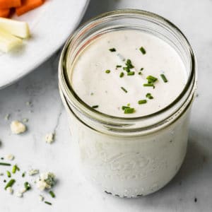 close up overhead view of blue cheese dressing in a glass mason jar