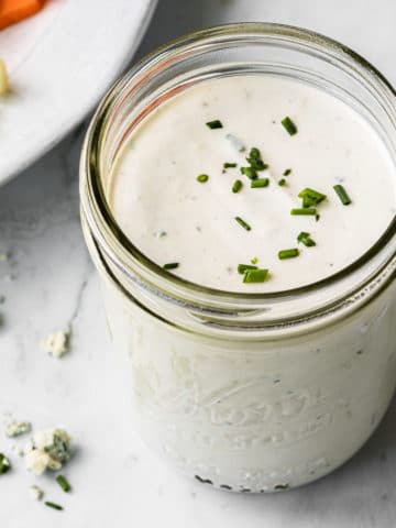 close up overhead view of blue cheese dressing in a glass mason jar