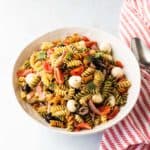 a white bowl with the finished recipe with a kitchen towel draped next to it