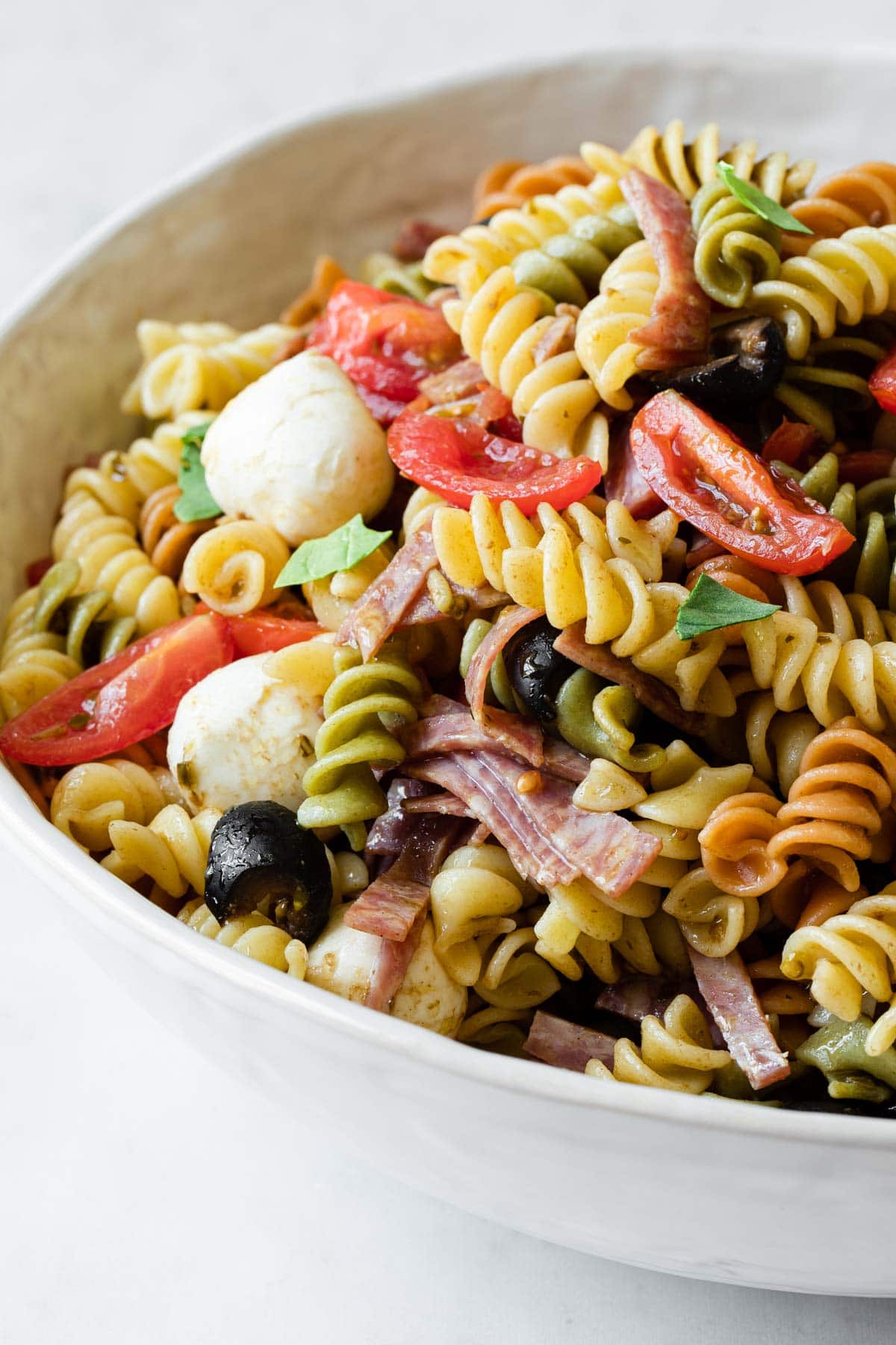 close up view to show the salad ingredients mixed with pasta