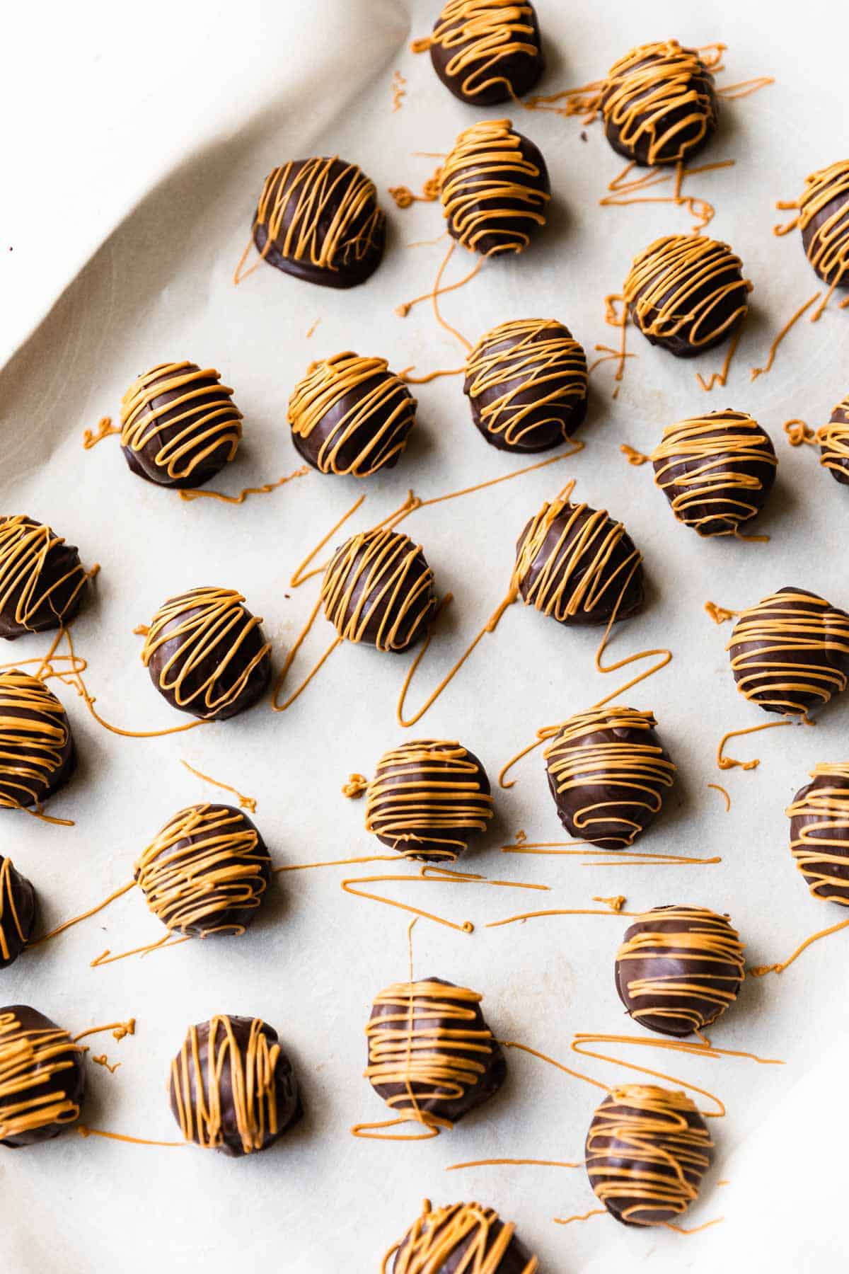 baking sheet with truffles being drizzled with melted butterscotch