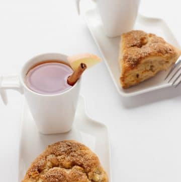 scones with cinnamon sugar on top and a hot drink on the same plate