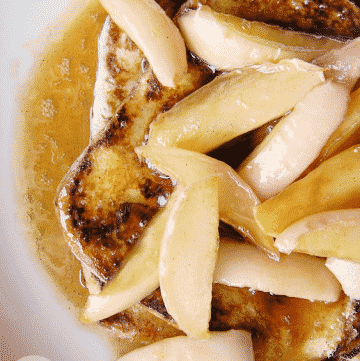close up of sliced apples over french toast