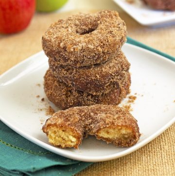 apple doughnuts stacked on on burlap cloth