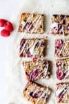 overhead view of raspberry bars drizzled with icing