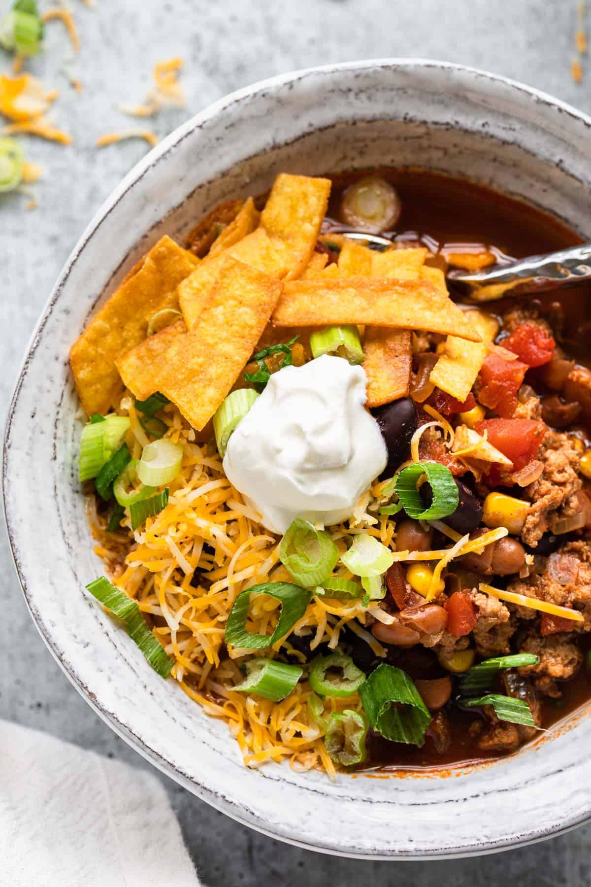 close up view of taco soup with toppings