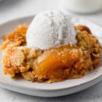 apple dump cake with a scoop of vanilla ice cream