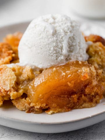 apple dump cake with a scoop of vanilla ice cream