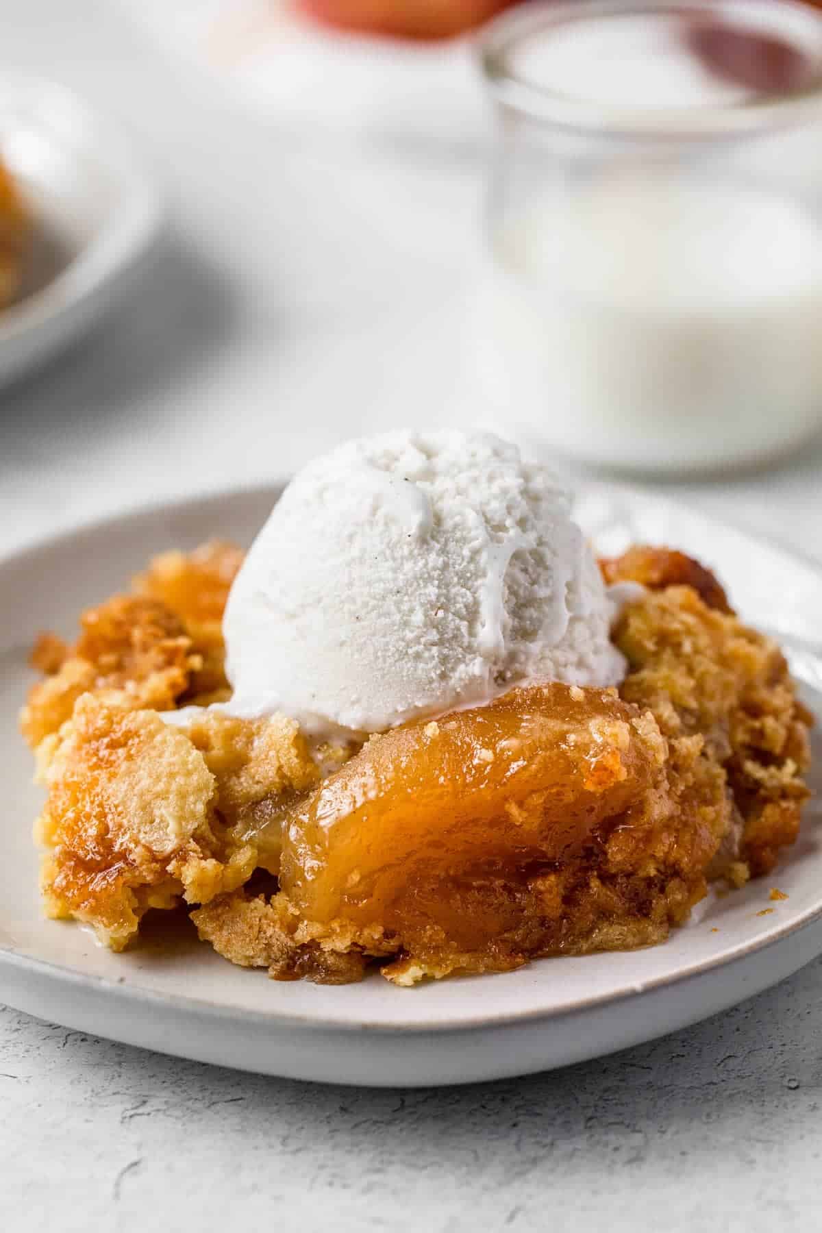 apple dump cake with ice cream on a small plate