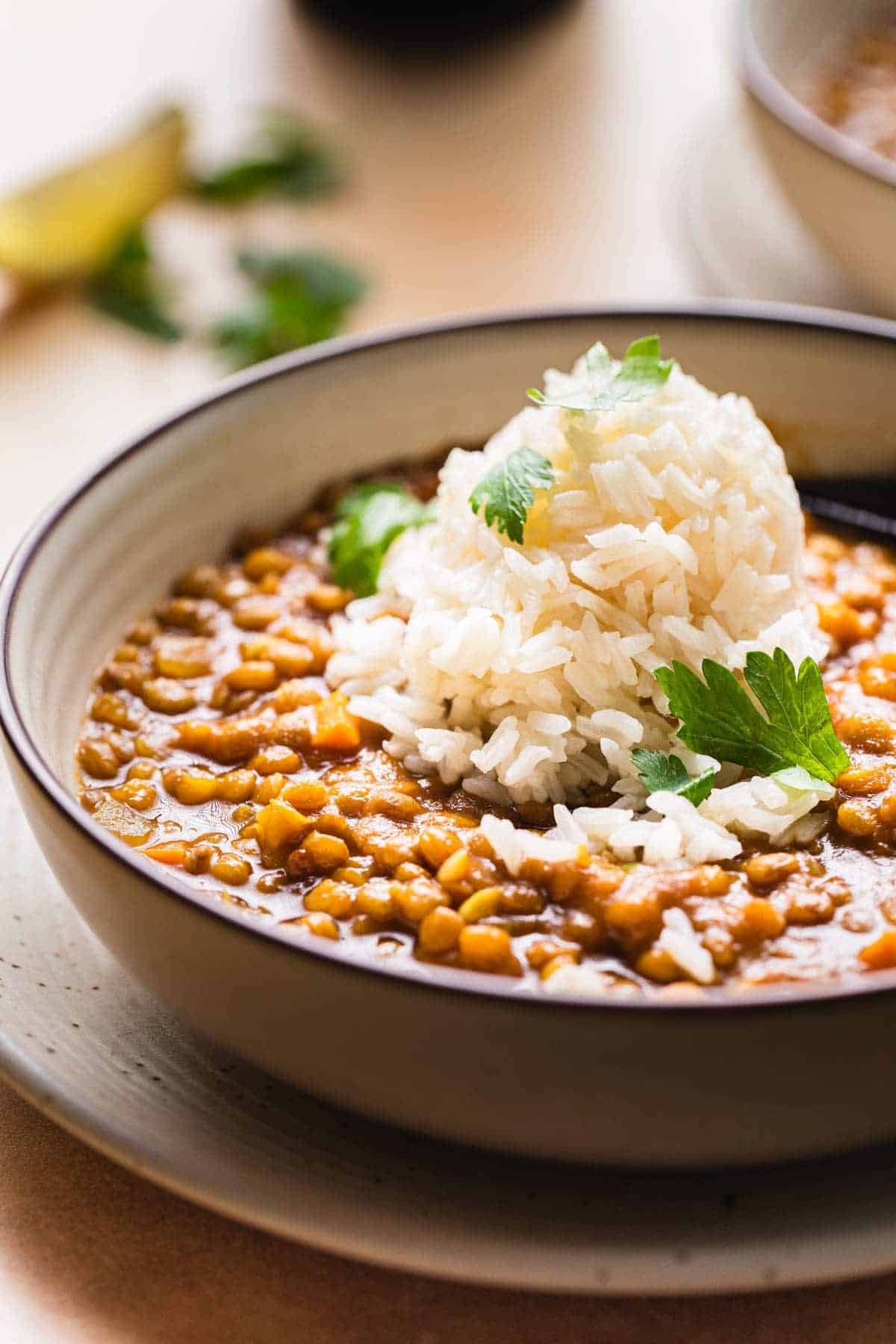 curry lentil soup with a mound of jasmine rice on top