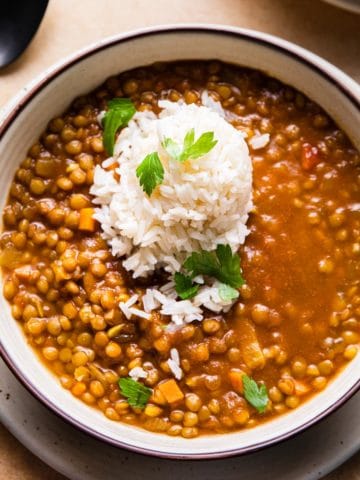 curry lentil soup topped with rice