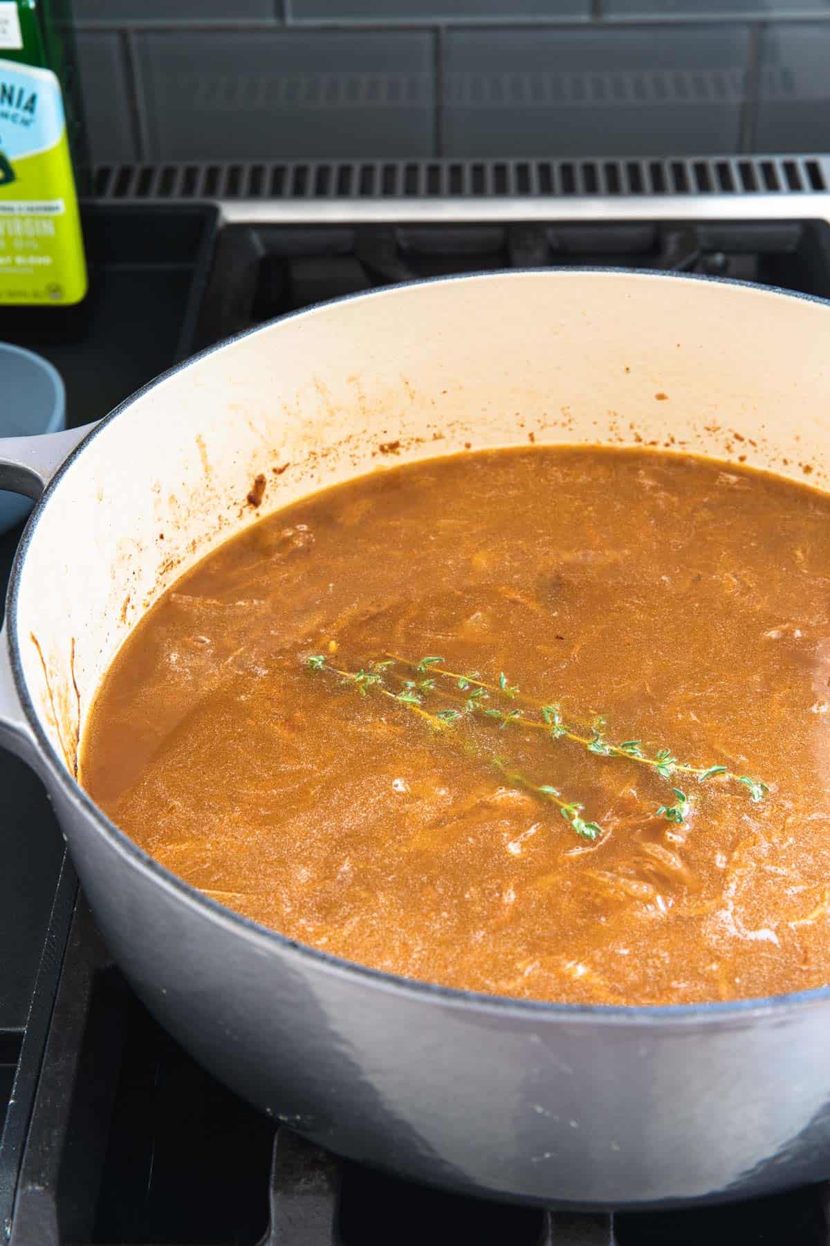 thyme springs in pot of soup on stove