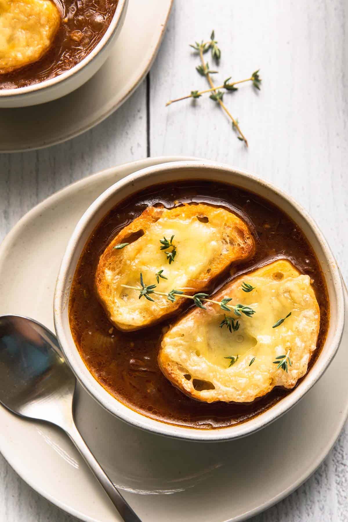 onion soup with thyme and cheesy toasted bread