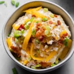 loaded mashed potatoes in a bowl close up