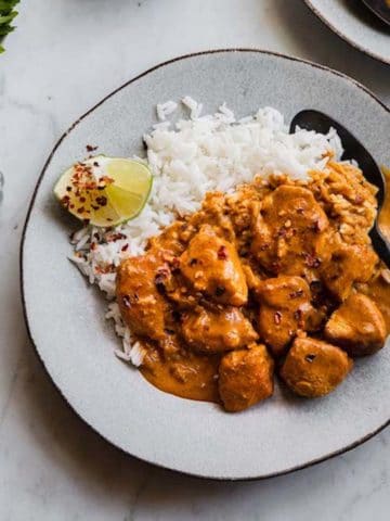 A plate of curry chicken and rice.